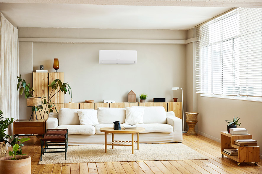 Wall-mounted air conditioning unit installed in a bright modern living room